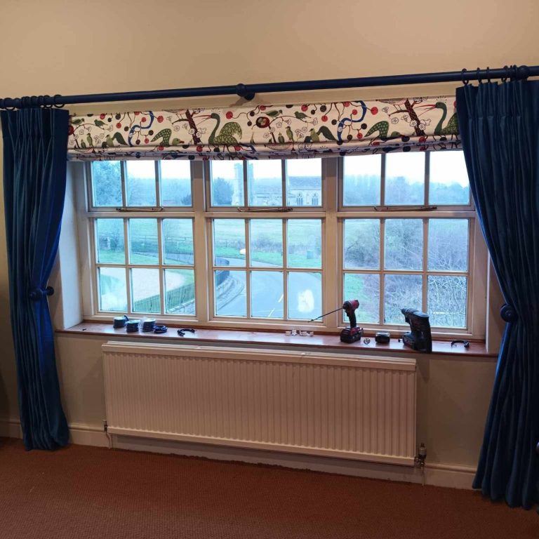 Made to measure Roman blind fitted in a living room for a soft, elegant window finish