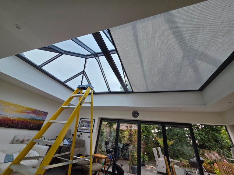 Motorised roof lantern blind undergoing fault diagnosis and repair, with an access ladder positioned beneath the large roof lantern