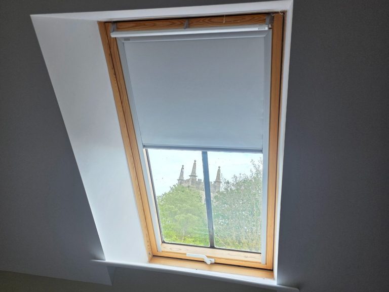 Made to measure blackout blind fitted to a Velux roof window for improved light control and privacy