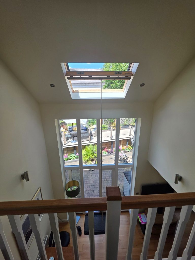 VELUX roof window positioned high above a staircase in Great Oxendon, Northamptonshire, requiring specialist access for solar blind